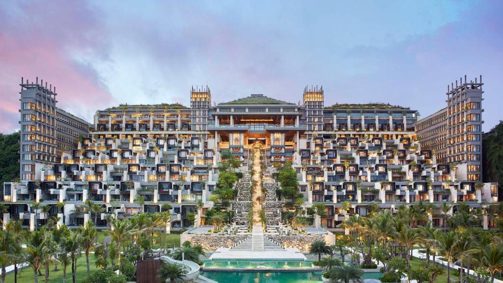 a large building with a fountain in front of it at The Apurva Kempinski Bali in Nusa Dua