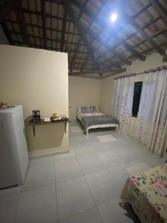 a room with two beds and a table in it at ALOHA - PRAIA DO SONO - in Paraty