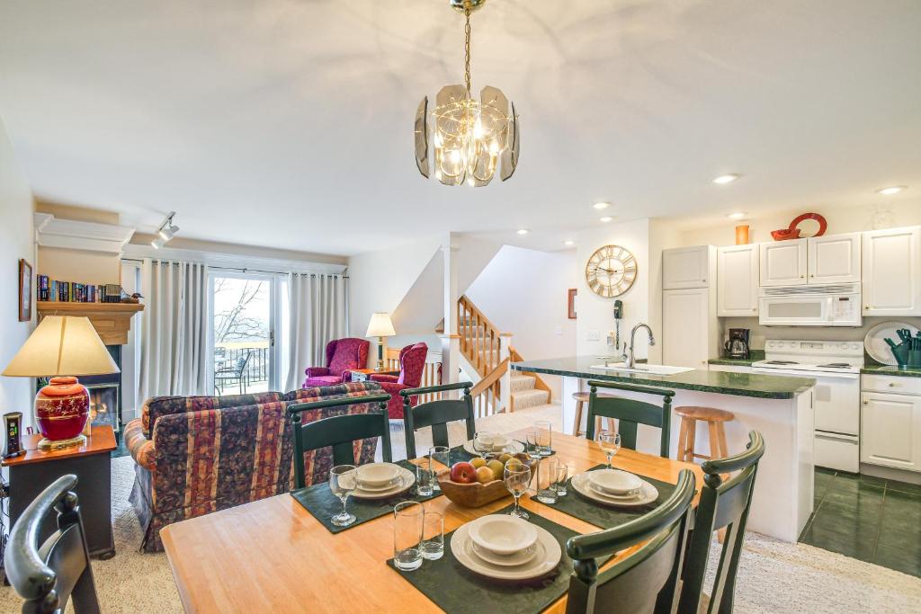 a kitchen and living room with a wooden table and a dining room at Charming Galena Townhome Near Belvedere Mansion! in Galena