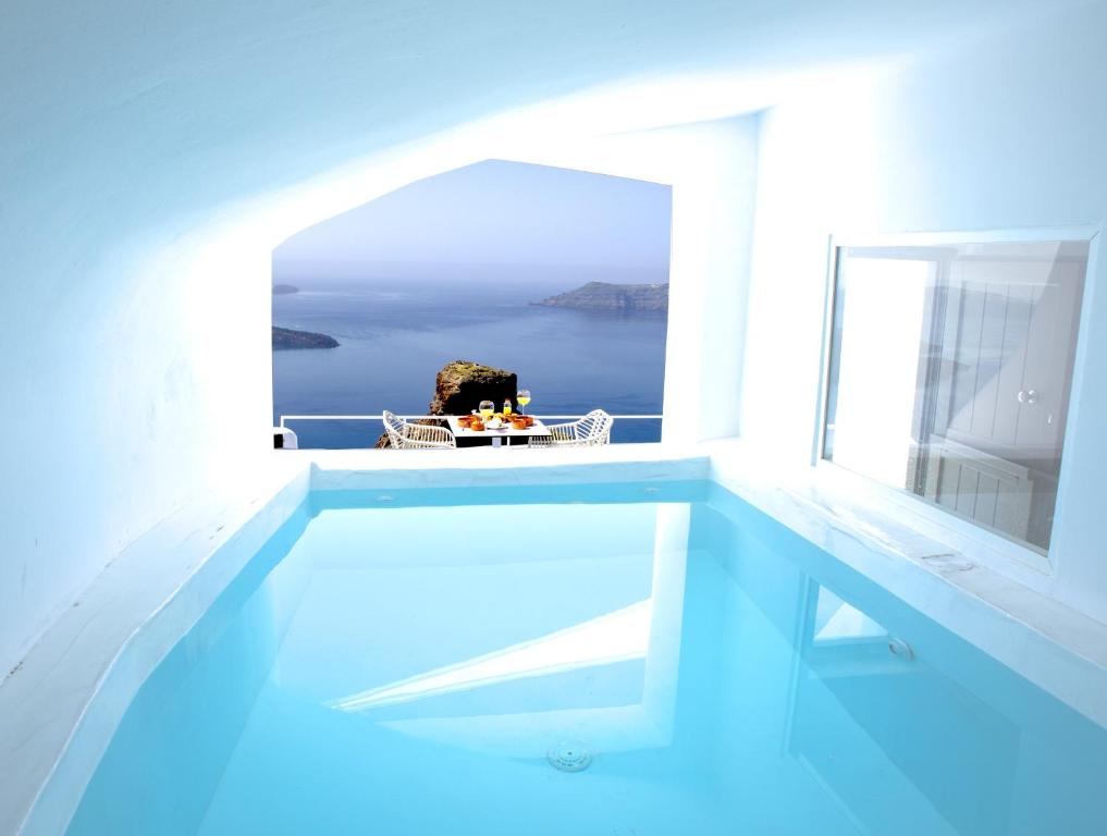 a swimming pool with a view of the ocean at Heavens Edge in Imerovigli