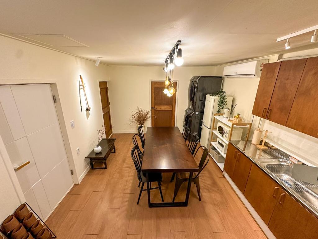 a kitchen with a table and chairs in a room at Yunseul- Garden House in the City with Korean Beauty in Seoul