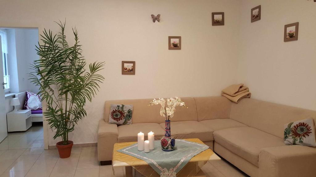 a living room with a couch and a table with candles at Holiday Apartment Essen in Essen