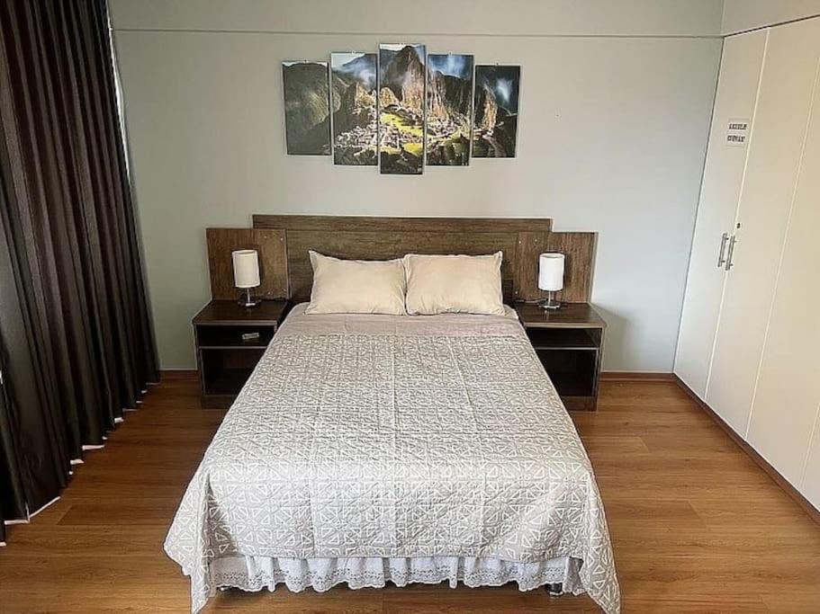 a bedroom with a large bed with two night stands at Trendy Mini Apartment in Miraflores in Lima