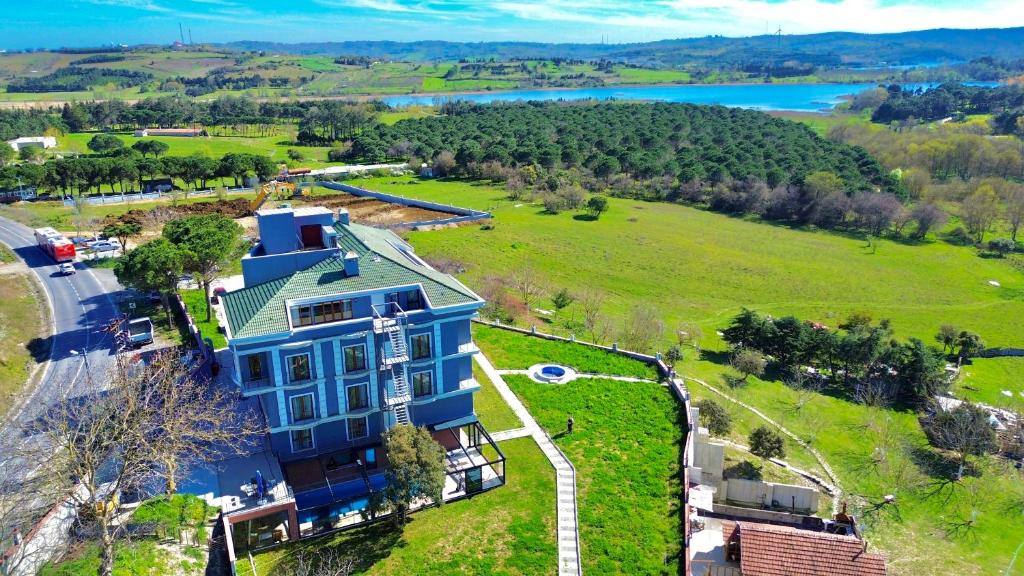 an aerial view of a large blue house on a green field at Green Roof Boutique Hotel & Spa in Terkos