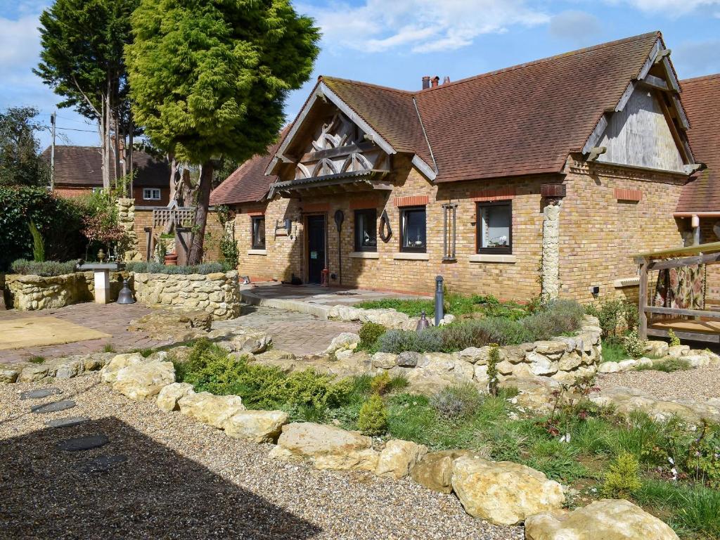 a large brick house with a stone yard in front of it at Bramley Cottage in Langley