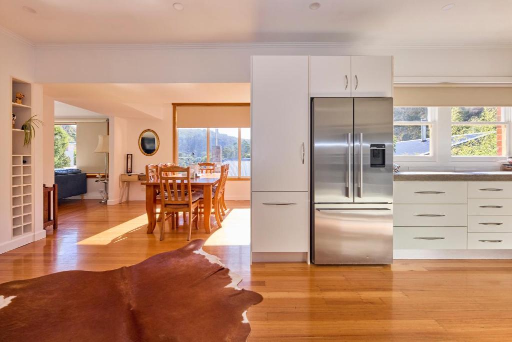 a kitchen and a dining room with a table at Basin Road Townhouse in Royal Park