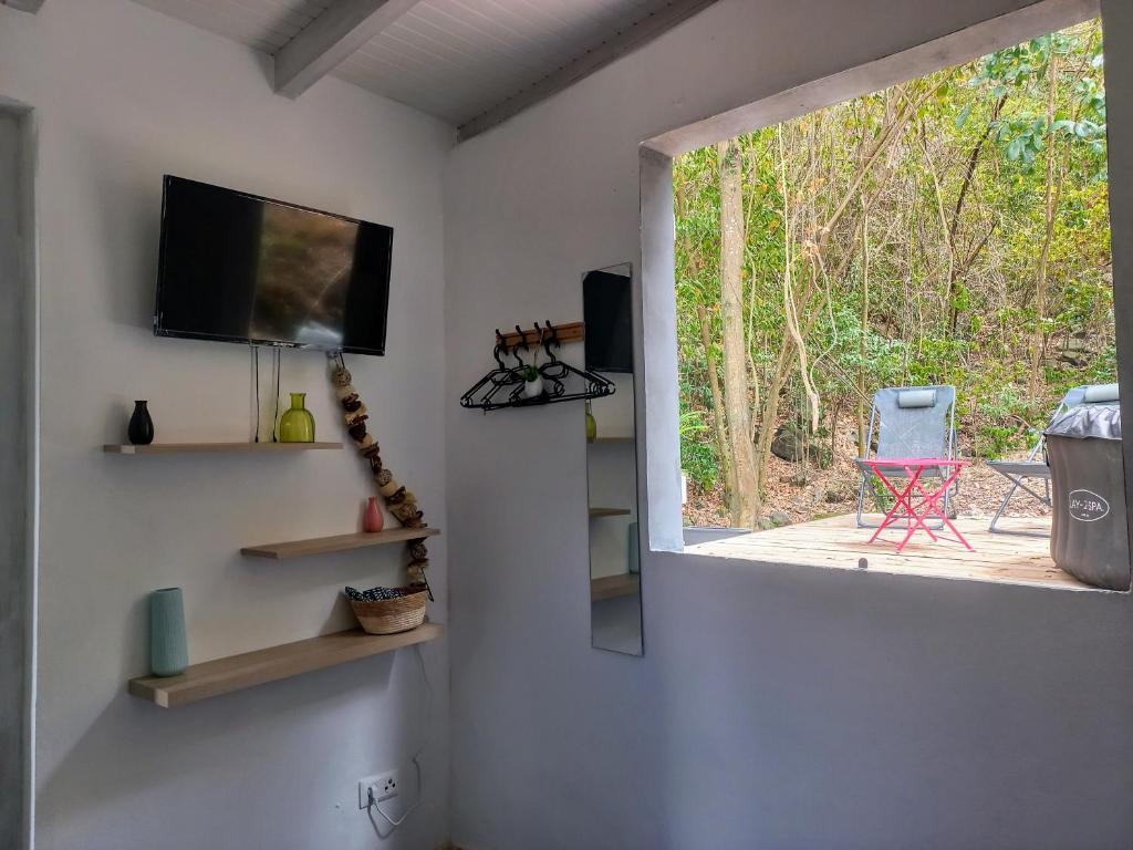 TV a/nebo společenská místnost v ubytování Tropi Kay' Location - Bungalow avec jacuzzi