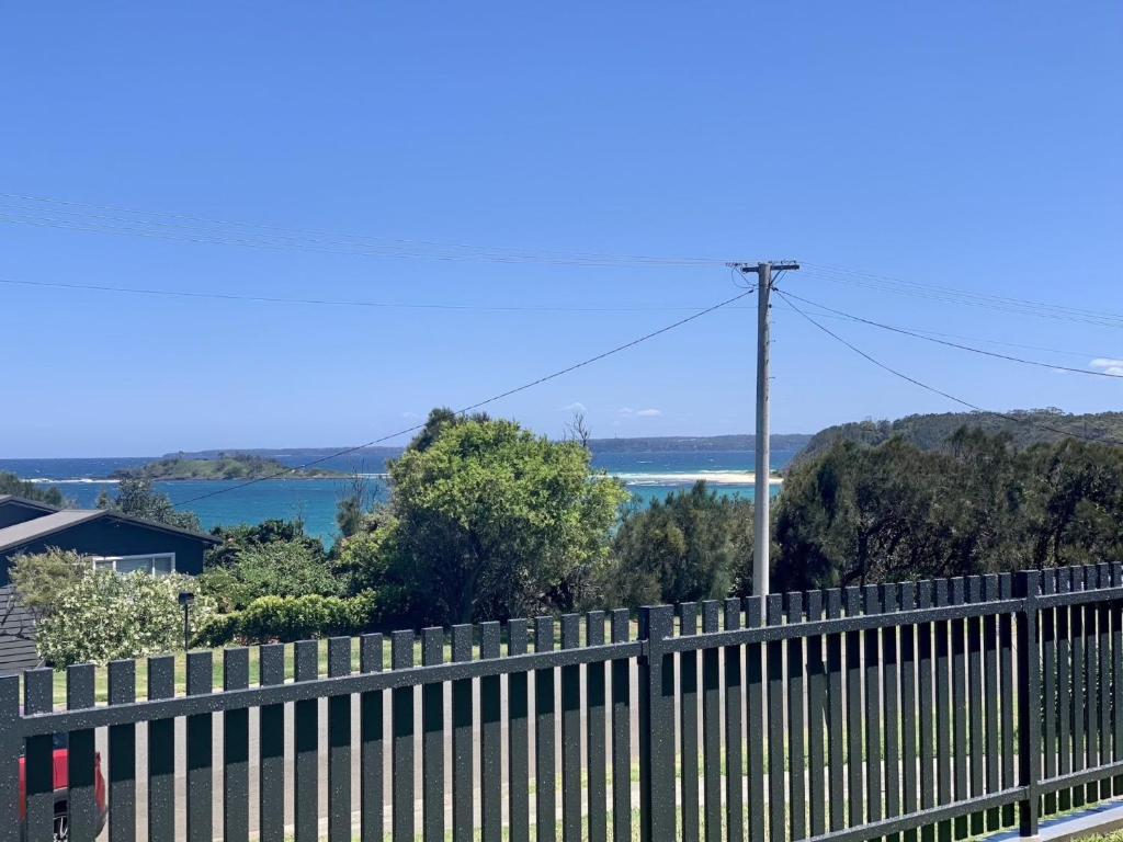 a fence with a view of the water at Life's A Beach in Manyana