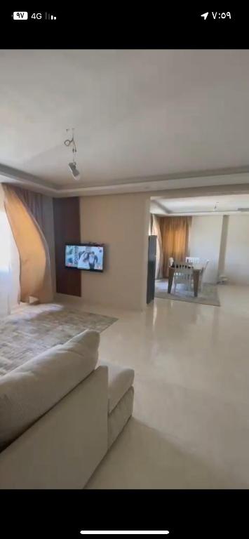 a living room with a bed and a tv at شقه فندقيه تشاهد النيل in Cairo