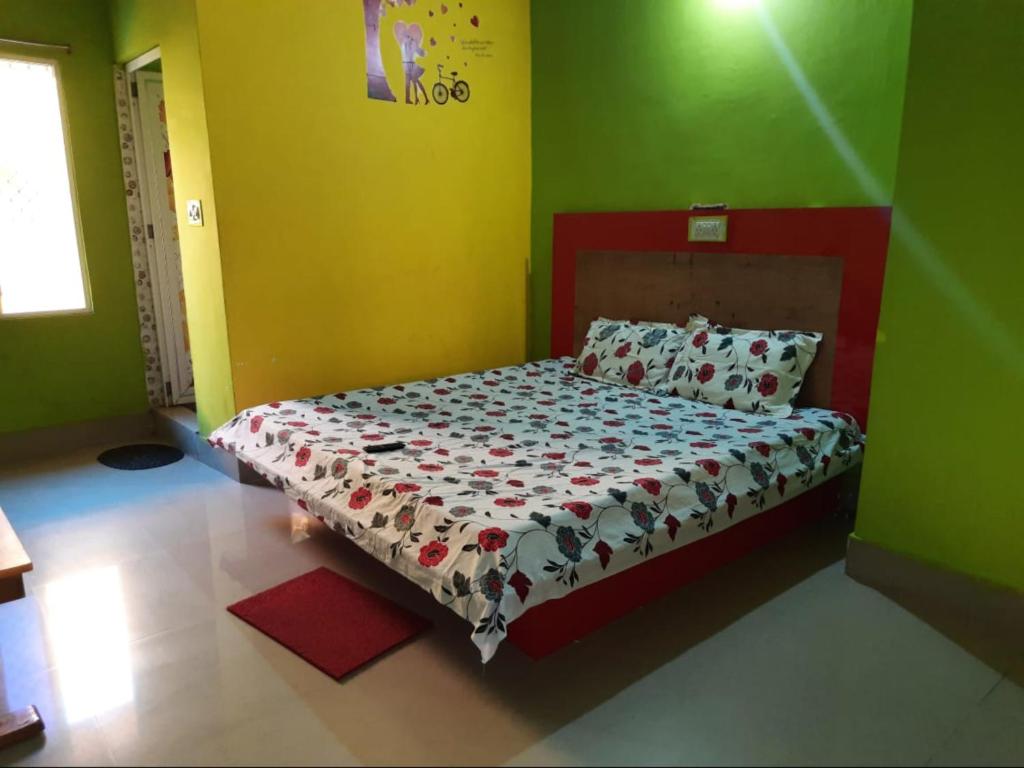 Cama en habitación con paredes verdes y amarillas en Hotel Sun Plaza Near Konark Sun Temple & Couple Friendly, en Konark