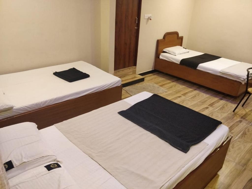 a room with two beds in a room at L OCEAN GUEST HOUSE in Puducherry