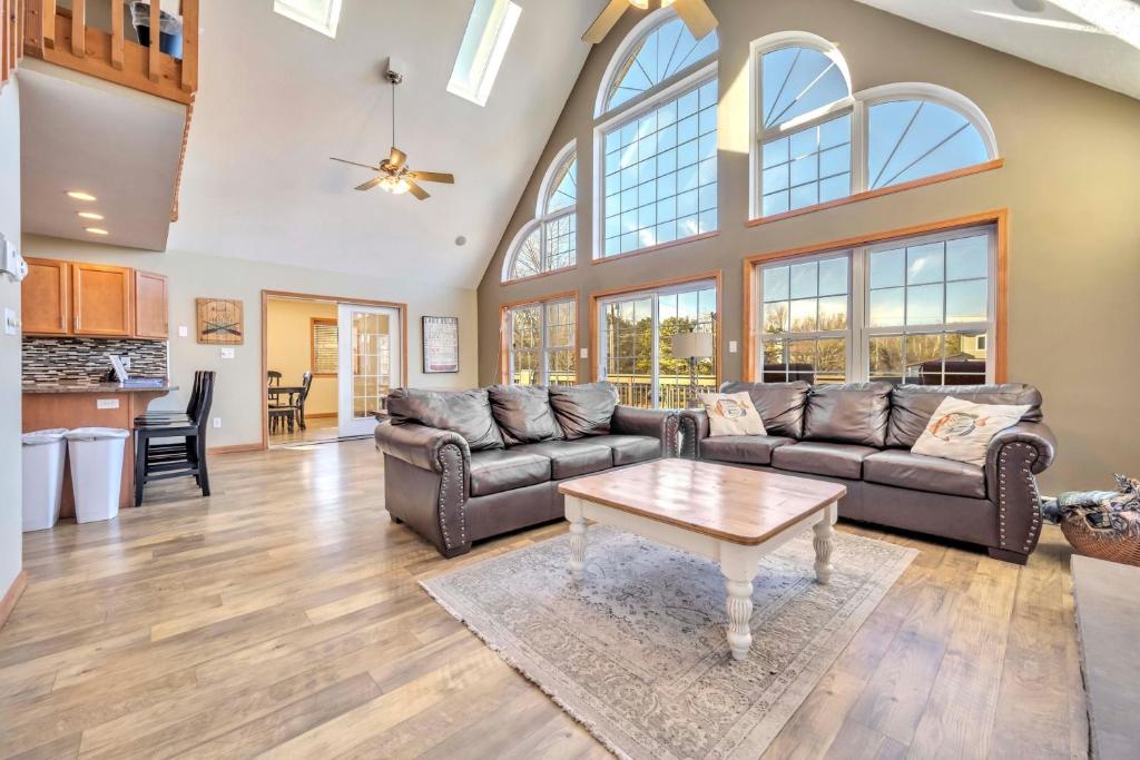 a living room with couches and a table at Pocono Pinnacle by AvantStay Steps to the Lake Game Room Large Deck in Albrightsville