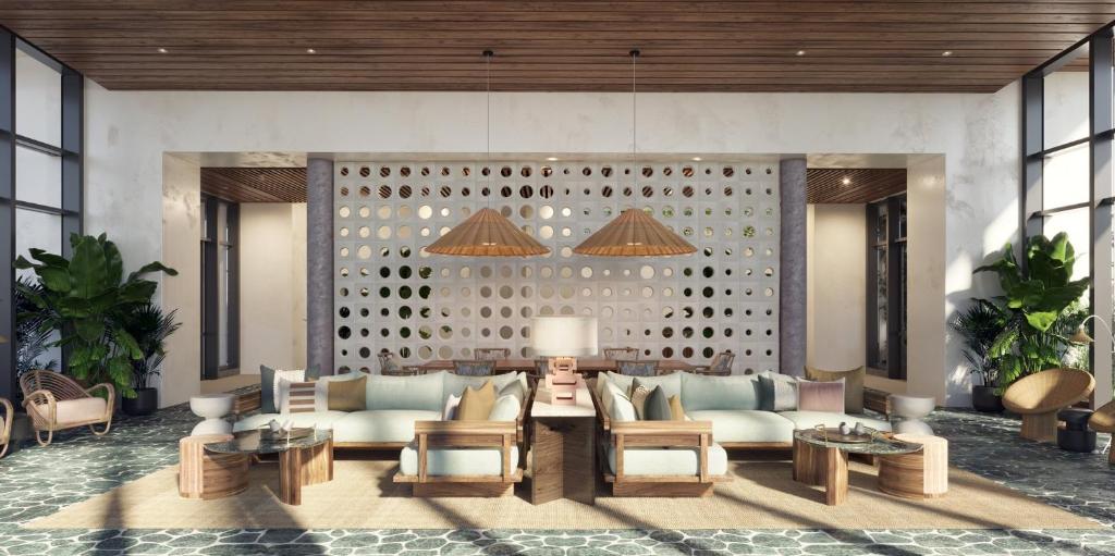 a lobby with a couch and chairs and tables at Hotel Indigo Grand Cayman, an IHG Hotel in Grand Cayman