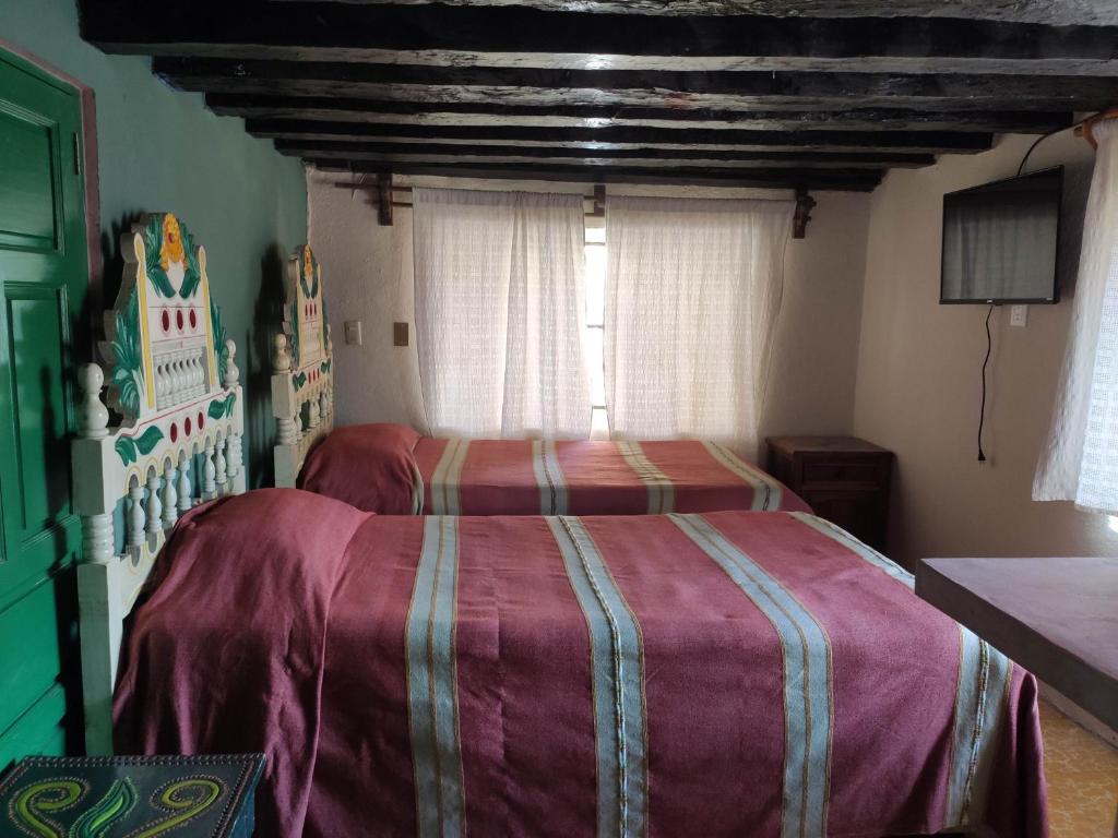 Postel nebo postele na pokoji v ubytování Hotel Mesón de la Salud