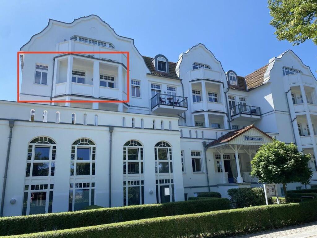 a large white building with a red stripe on it at Luxury & design with sea view in Kühlungsborn