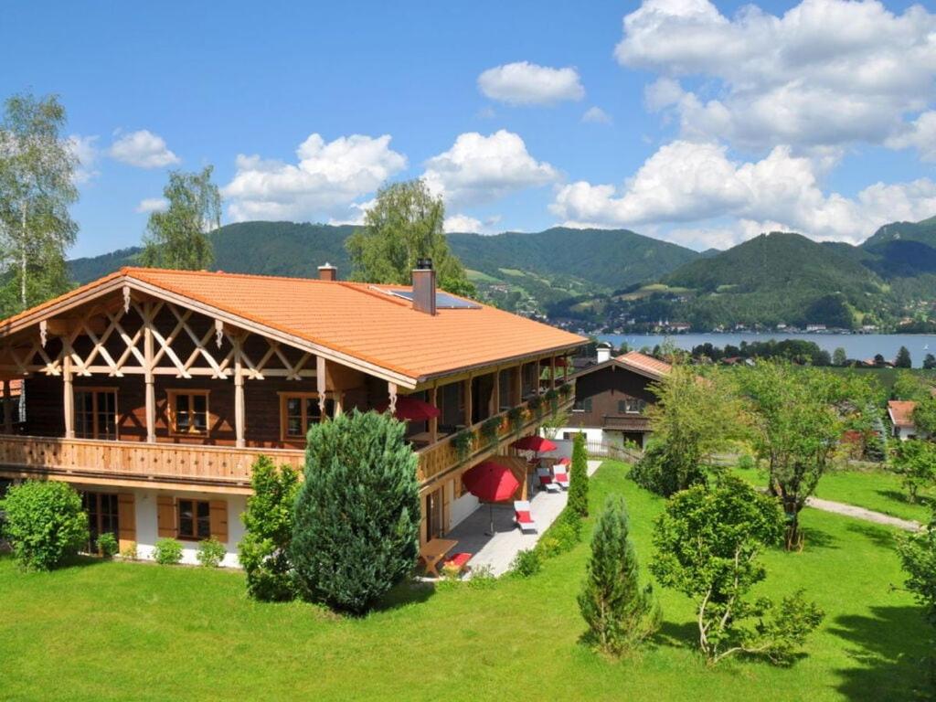 una casa su una collina con un lago sullo sfondo di Suite Beech Modern retreat a Bad Wiessee