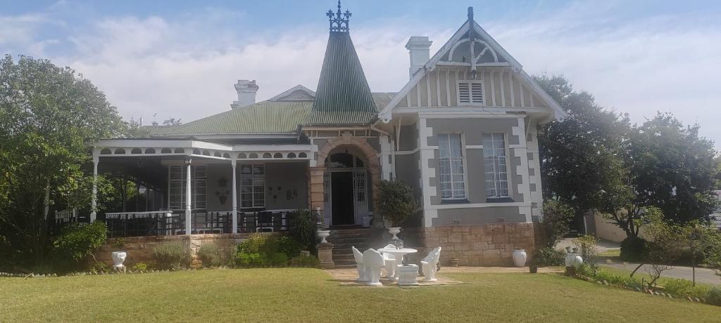 a large house with a steeple on a lawn at Heidelberg Central B&B in Heidelberg