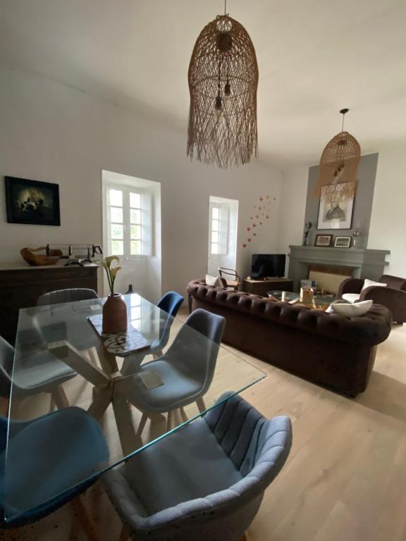 a living room with a couch and a table and chairs at T2 Paisible et cosy in Sollacaro