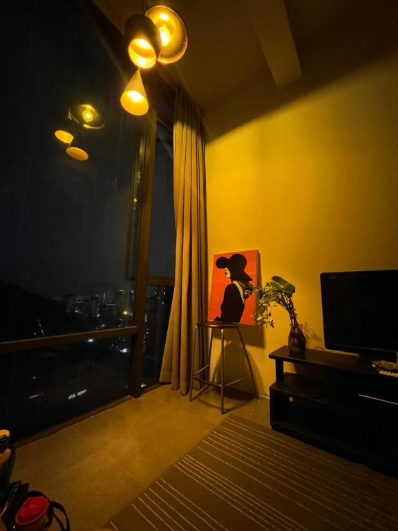 a living room with a painting of a cat on a table at Empire damansara in Petaling Jaya