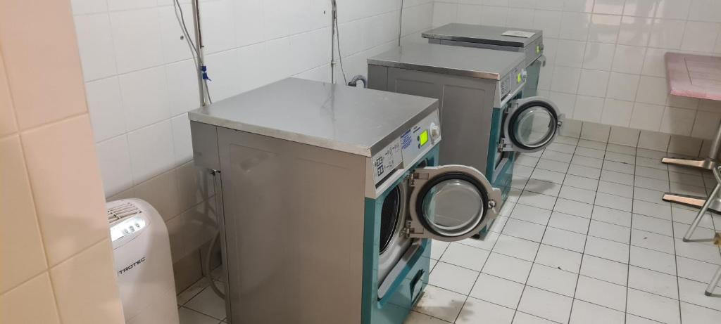 a bathroom with two washers and a washing machine at Le Porteur de Glace Classé 2 étoiles in Aulus-les-Bains