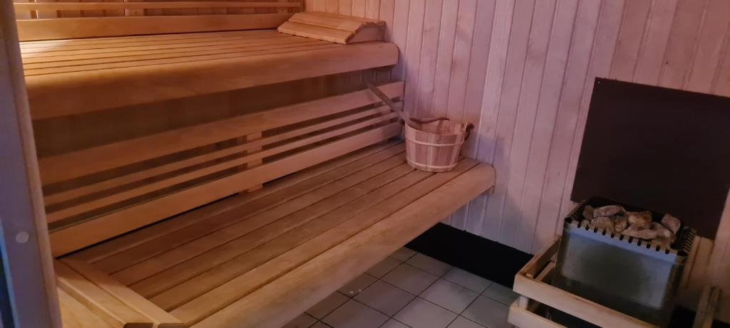 a sauna with a wooden bench in a room at Le Porteur de Glace Classé 2 étoiles in Aulus-les-Bains