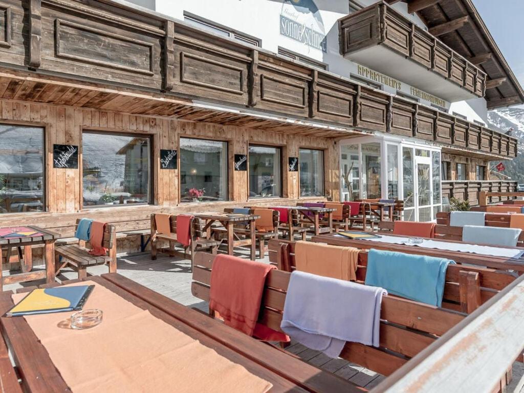 a restaurant with wooden chairs and tables and tablesktop at Sun & snow in Kühtai in Kühtai