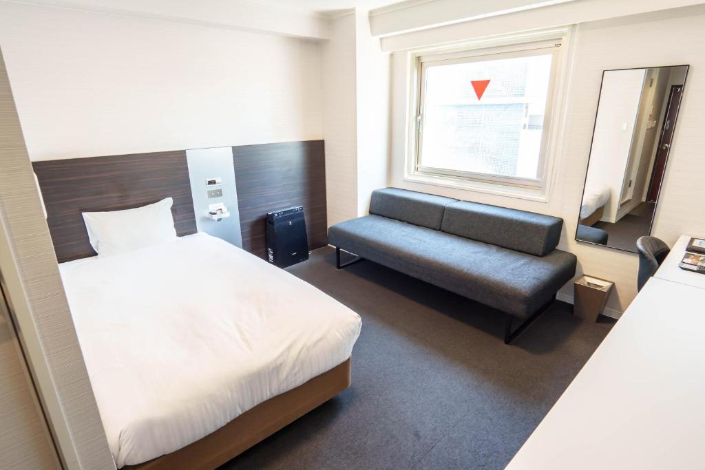 Postel nebo postele na pokoji v ubytování Osaka City Hotel Kyobashi