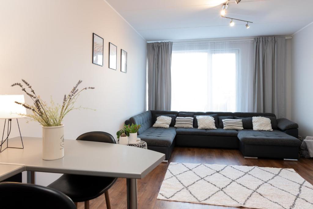 a living room with a couch and a table at Jaamamõisa apartement in Tartu