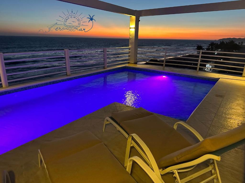 a swimming pool with a view of the ocean at Condominio Aeromar in Acapulco