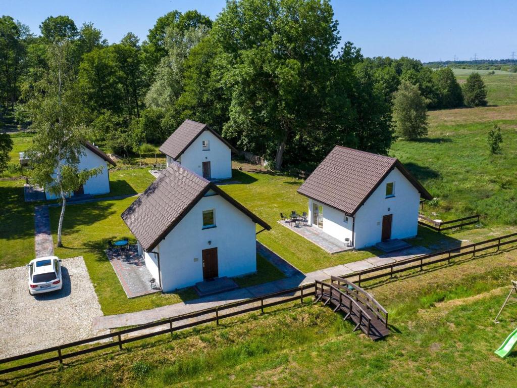 an aerial view of two houses in a field at Brick Cottage near Baltic Sea and Windmill in Lędzin