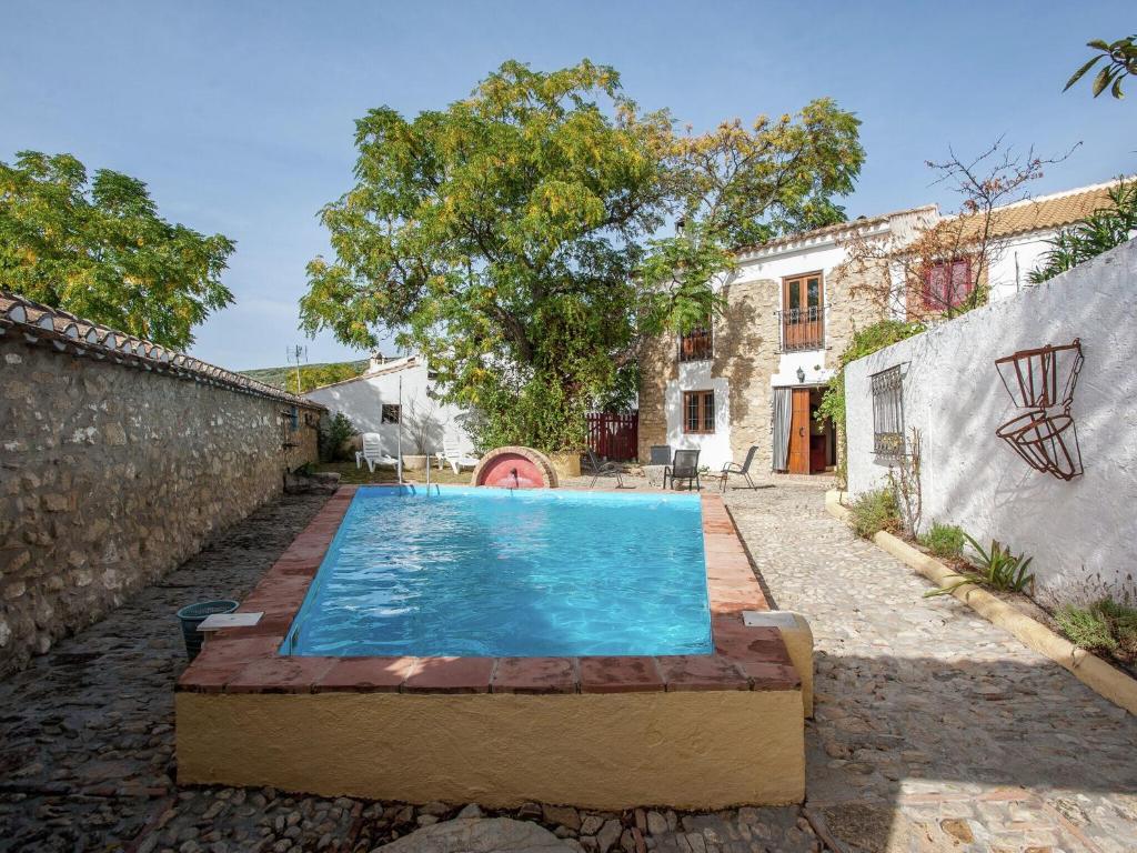 una piscina en el patio trasero de una casa en Restored mill on a property in Algarinejo in Granada, en Fuentes de Cesna
