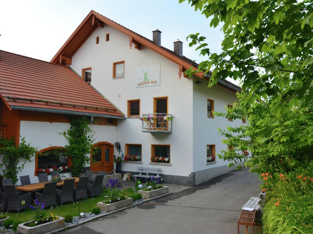 a white building with a lot of chairs in front of it at Holiday home with panoramic view and every convenience spa in Waldkirchen