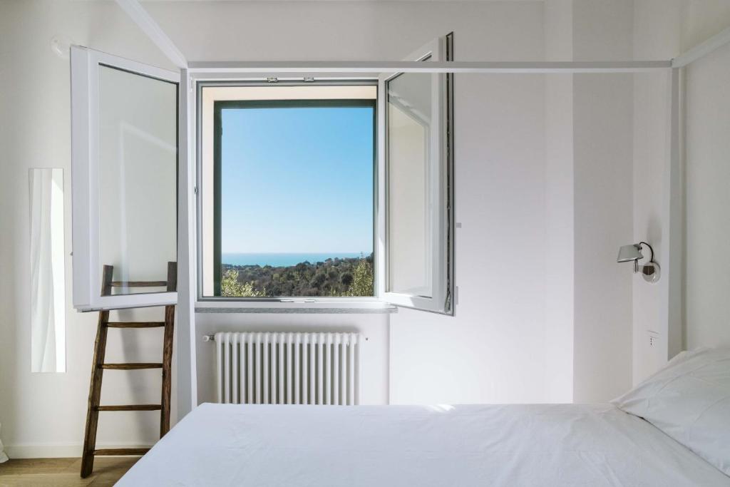 a bedroom with a bed and a window at ABC affittacamere in Celle Ligure