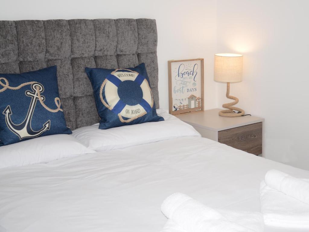 a bedroom with a bed with a soccer ball pillow at Swn Y Mor - Sound of the Sea - by Aberporth Beach Holidays in Aberporth