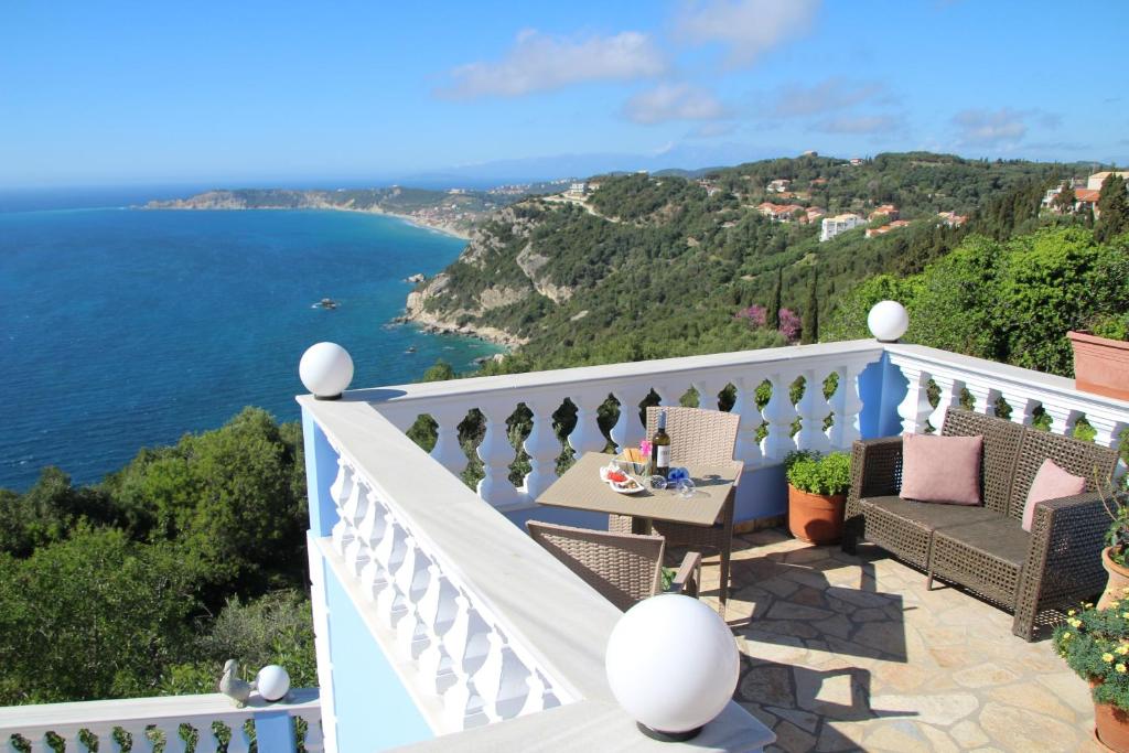 a balcony with a view of the ocean at Villa Bettina 2nd floor in Afionas