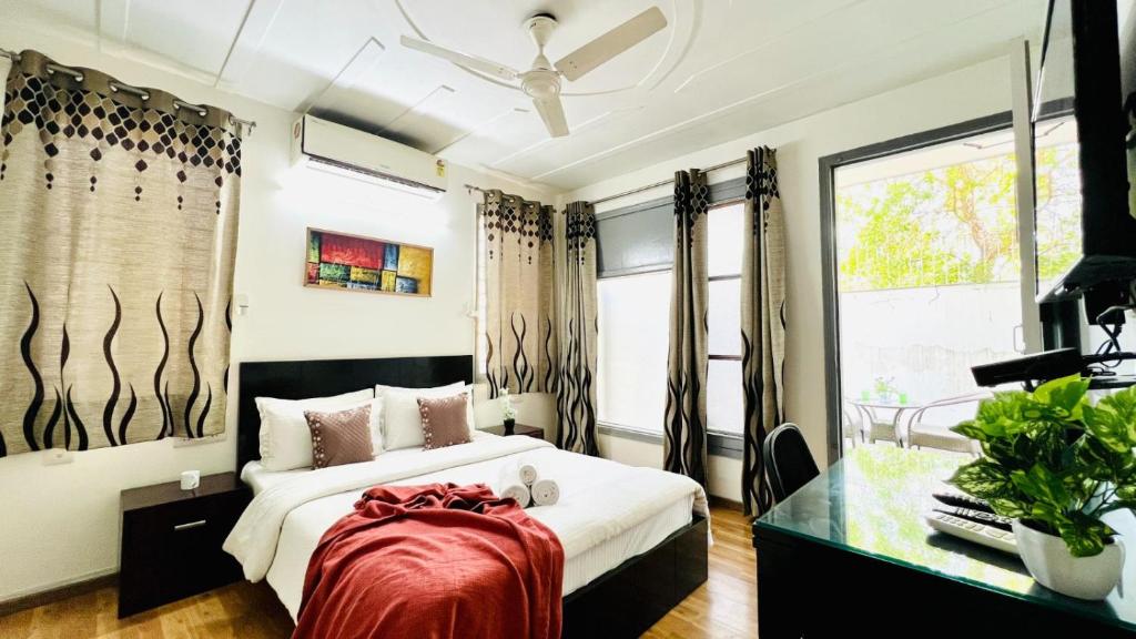 a bedroom with a large bed and a window at Olive Service Apartments - Medanta Medicity in Gurgaon