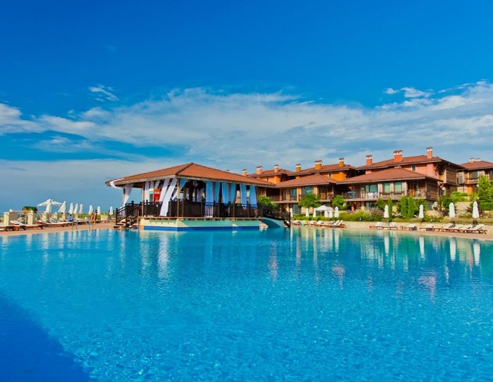 a resort with a large pool of blue water at СОЗОПОЛ - MORE SUN СОЗОПОЛИС 2 Б in Burgas City