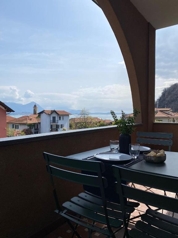 a table and chairs on a balcony with a view at Appartamento Filippo in Baveno