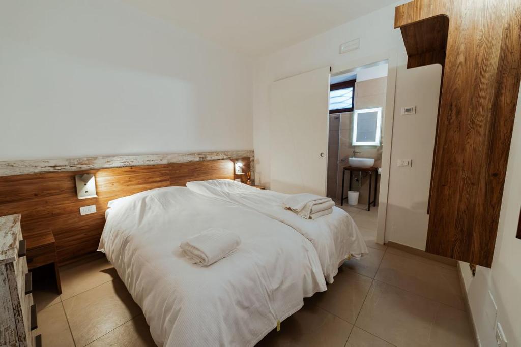 a bedroom with a large bed with two pillows on it at Hotel Alla Sosta in Rezzato