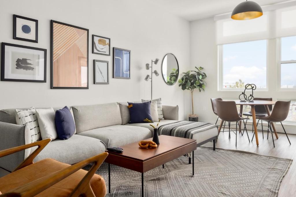 a living room with a couch and a table at City Views - Lifestyle Loft - Zuni Lofts in Denver