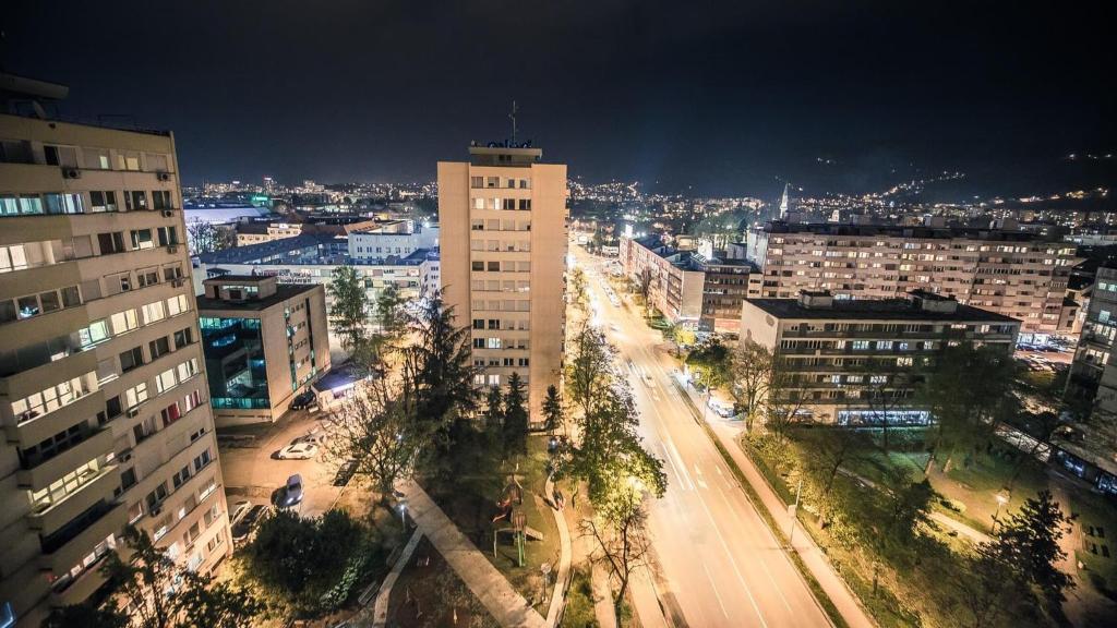 a city at night with a street and buildings at 5 min Apartment in Banja Luka