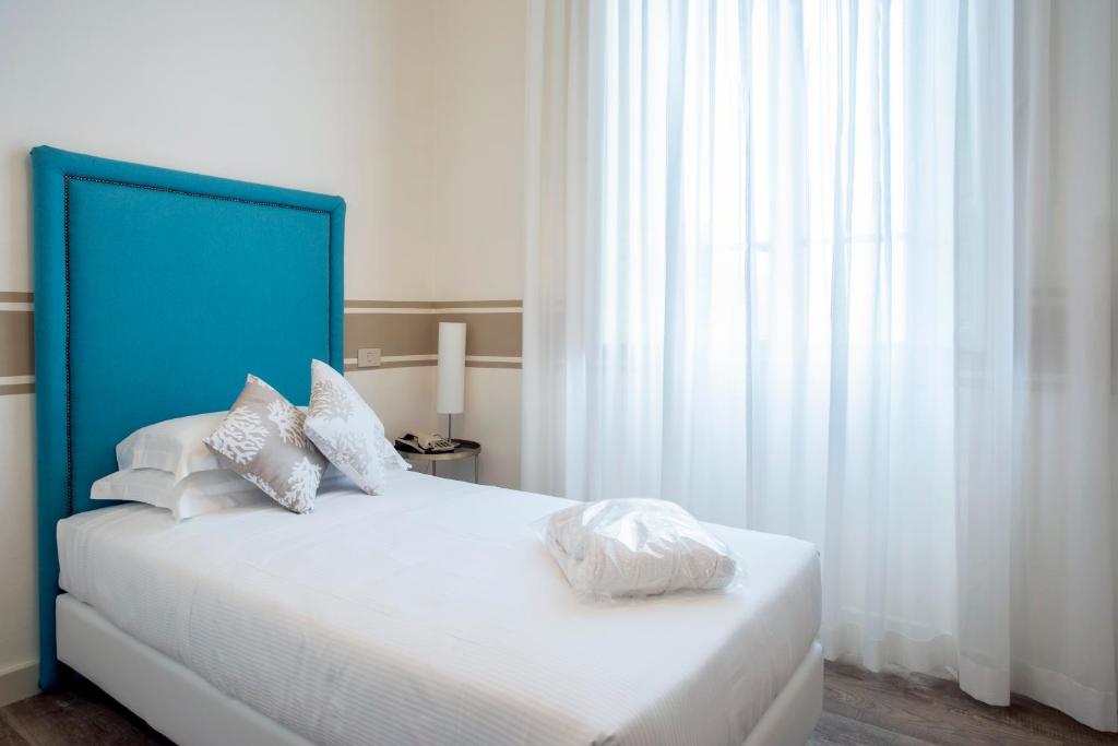 Postel nebo postele na pokoji v ubytování Hotel Olimpia