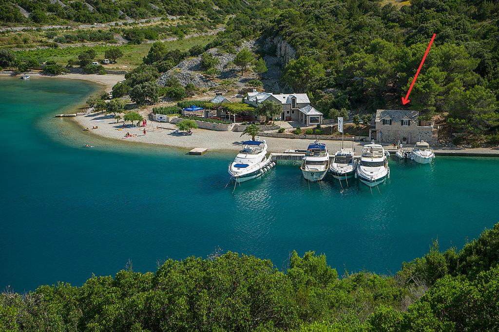a group of boats are docked in a harbor at House Ana in Pučišća