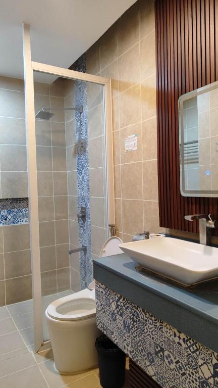 a bathroom with a toilet and a sink at Eagle Point Beach and Dive Resort in Mabini