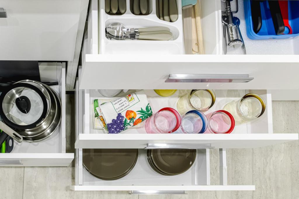 an open refrigerator filled with lots of dishes at Appartamento San Carlo in Tirano