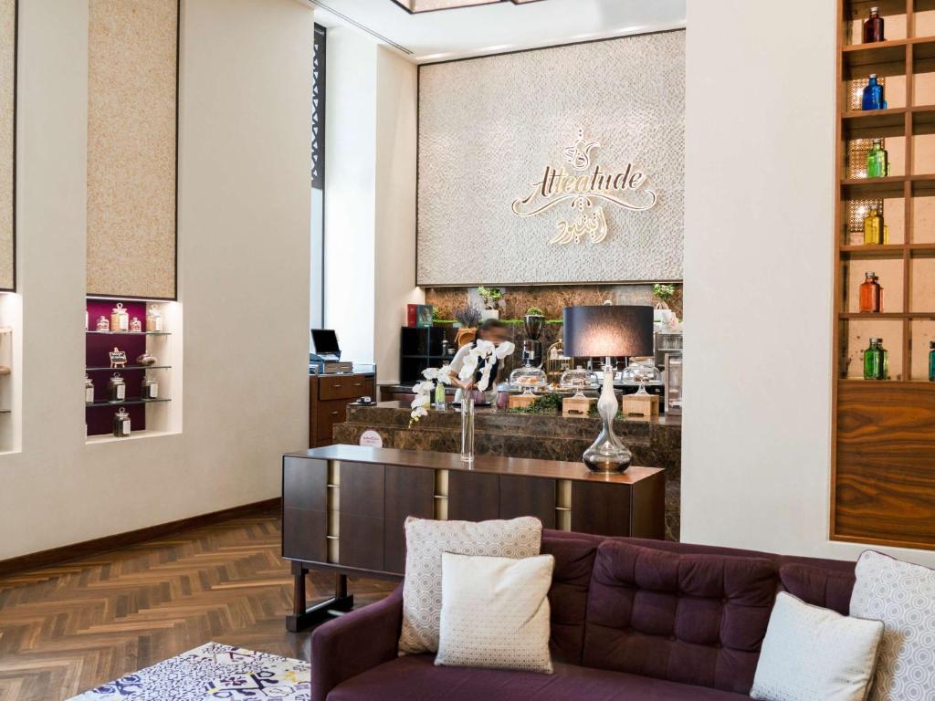 a lobby of a liquor store with a couch at Alwadi Hotel Doha - MGallery Collection in Doha