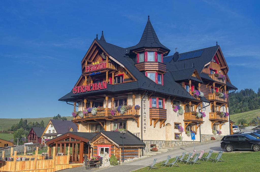 a large tall building with a gambrel at Wellness Penzion Strachan in Ždiar