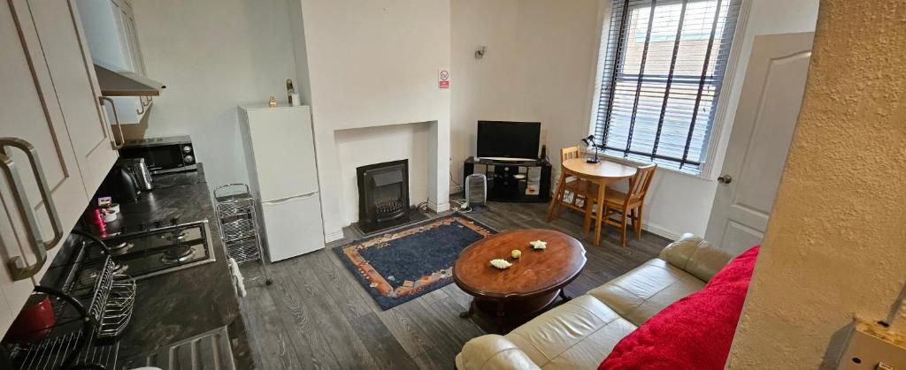 a living room with a couch and a table at The Luxe - Entire House in Huddersfield