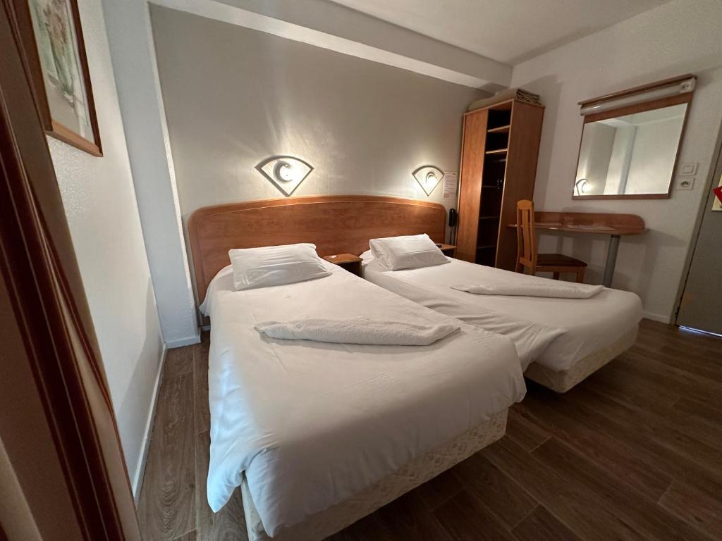Postel nebo postele na pokoji v ubytování HAVANA Hôtel