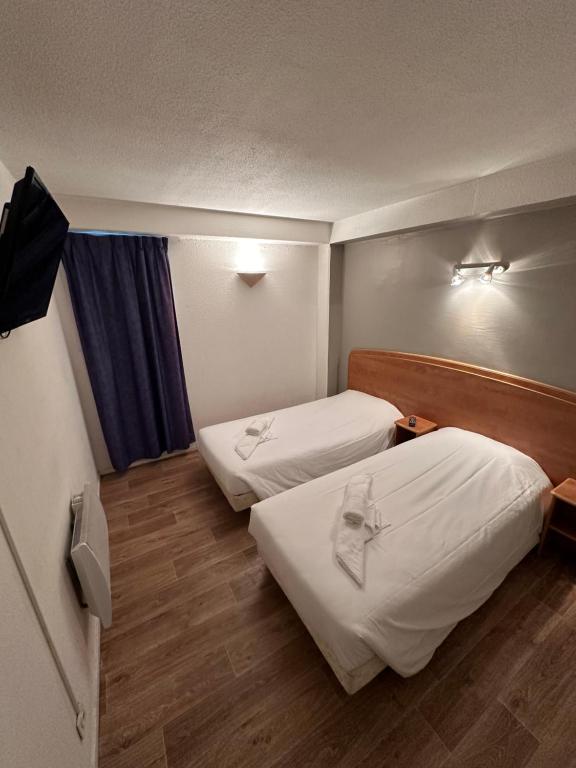 Postel nebo postele na pokoji v ubytování HAVANA Hôtel